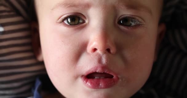 Baby boy looking at camera with sad face close-up - Footage, Video