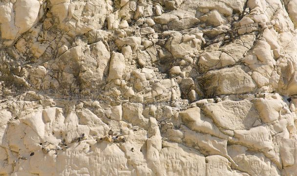 Rough rock surface texture with brown rocks - Photo, image