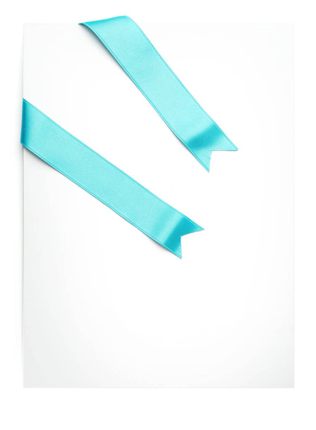Blank paper card with turquoise satin ribbons on white background - Foto, Bild