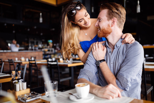 Beautiful man and woman flirt in cafe - Zdjęcie, obraz