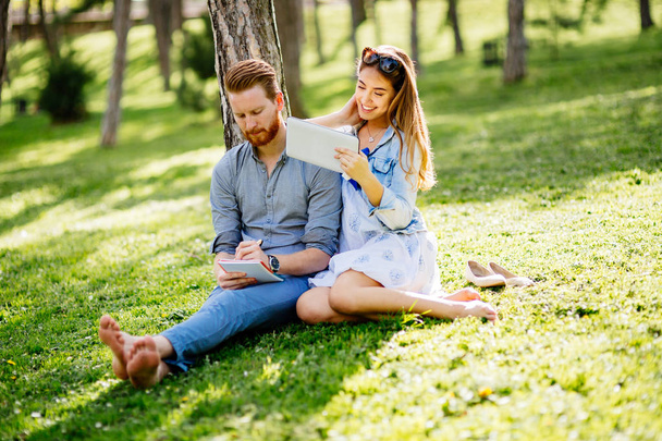 Beautiful couple studying together for exams in nature - Photo, image