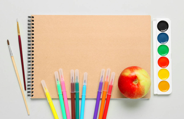 Set of school stationery with apple on light background - Foto, Bild