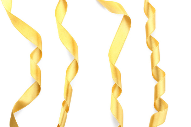 Золотые атласные ленты на белом фоне
 - Фото, изображение