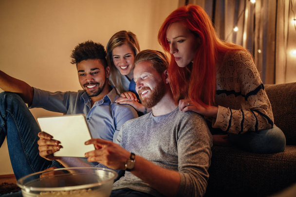 Friends watching a movie on digital tablet at home. - Fotoğraf, Görsel