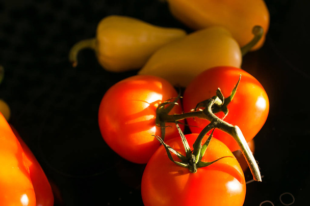 beautiful tasty vegetables are in the kitchen. Tomatoes, peppers and greens - Фото, зображення
