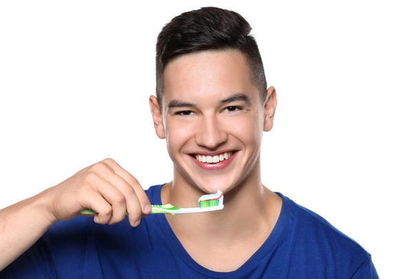 Giovane uomo lavarsi i denti su sfondo bianco
 - Foto, immagini