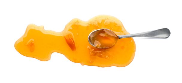 Spoon with sweet apricot jam on white background - Foto, immagini