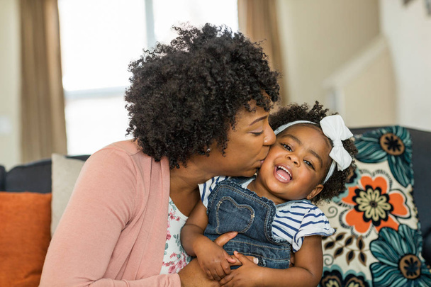 African American family. Mother and daughter smiling at home. - Foto, immagini