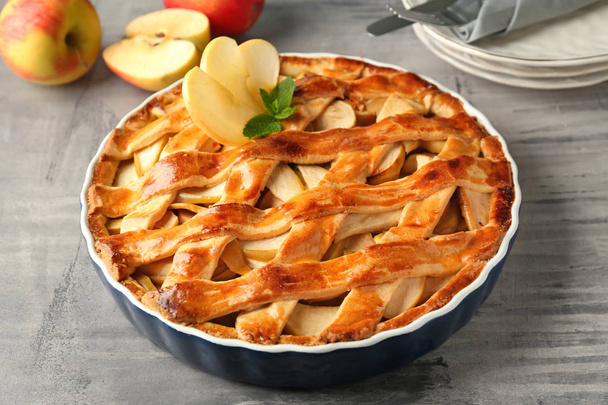 Dish with delicious apple pie on table - Photo, Image