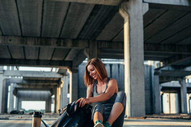 Photo of a smiling young woman preparing for a workout. - Photo, image