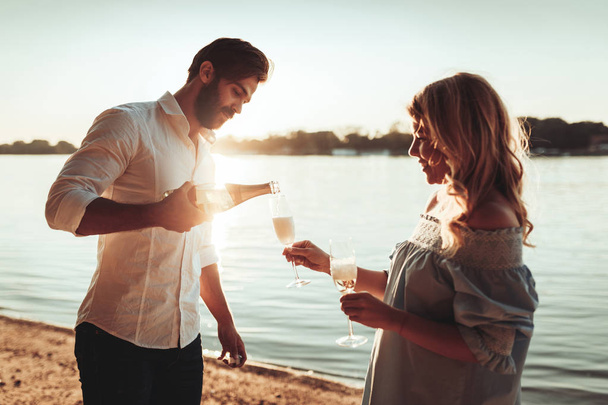 Couple enjoying wine while drinking together. - Foto, imagen