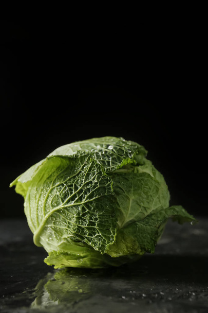 Fresh cabbage on dark background - Фото, изображение