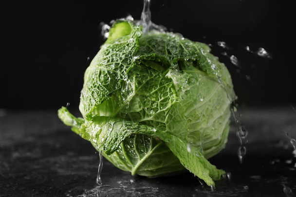 Fresh cabbage with drops of water on dark background - Фото, изображение