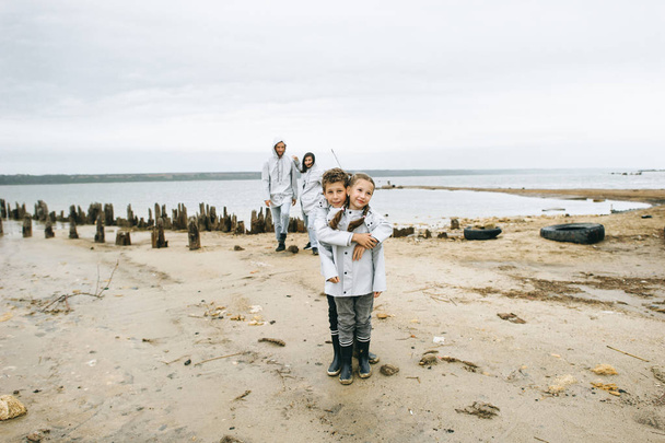 happy young family having a fun near the sea at cloudy weather - Foto, imagen
