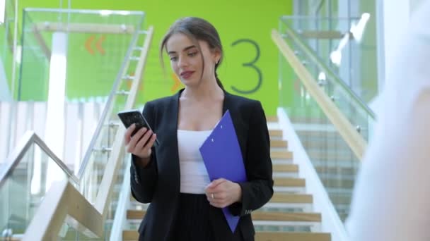 Business Center. Woman Talking On Phone In Office Building. Young Female With Smartphone On Stairs Indoors - Filmmaterial, Video