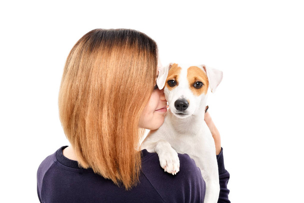 Portrait of a cute dog Jack Russell Terrier on the shoulder of its owner, isolated on white background - Fotó, kép