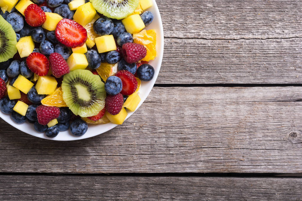 Fresh fruit and berries salad . Healthy vitamin food background . - Фото, изображение