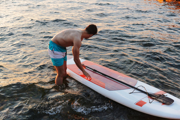 Image of young handsome man kayaking on lake sea. - Φωτογραφία, εικόνα