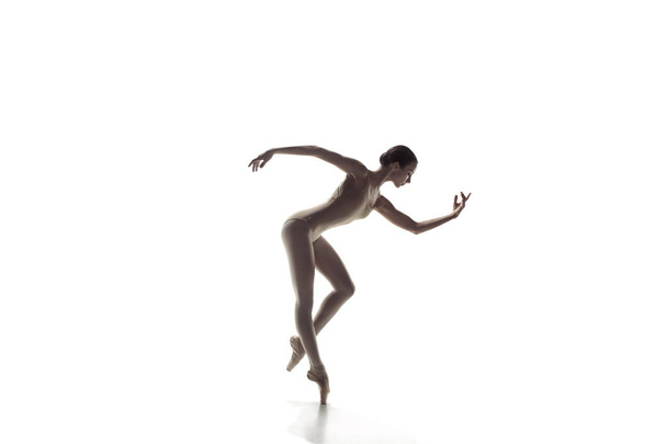 Ballerina. Young graceful female ballet dancer dancing isolated on white. Beauty of classic ballet. - Fotó, kép