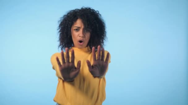 Angry annoyed woman raising hand up to say no stop. Sceptical and distrustful look, feeling mad at someone. Afro girl facial expressions, emotions and feelings. Body language. - Filmagem, Vídeo