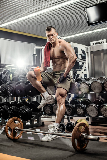 very power guy - bodybuilder, execute exercise with weight, inside gym, vertical photo - Zdjęcie, obraz