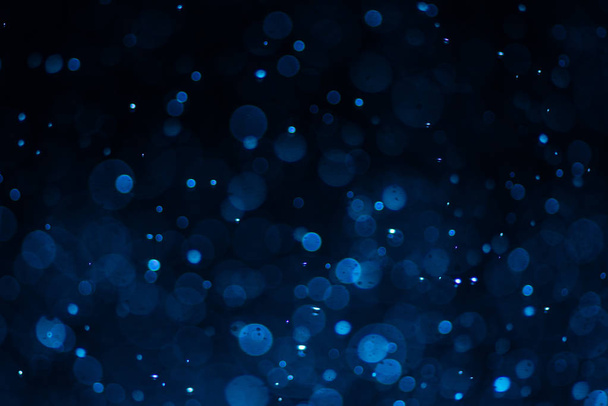 Abstract blue bokeh with black background - Photo, image