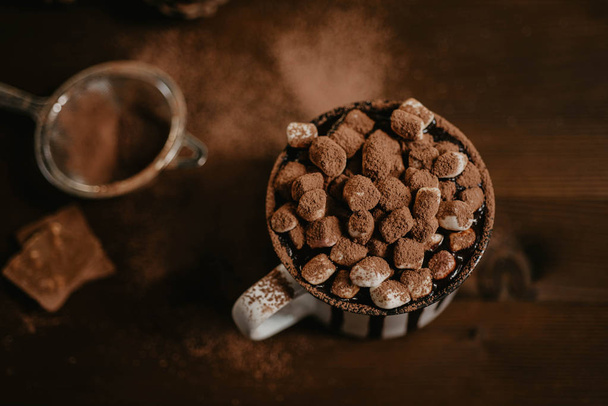 Горячий шоколад с зефиром конфеты, зимнее потепление сладкий напиток в кружке на деревянном фоне, избирательный фокус
 - Фото, изображение