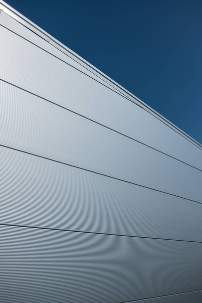 Modern building facade covered with steel sandwich panels in silver color - Foto, Imagem