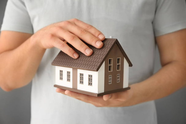 Man holding house model, closeup. Mortgage concept - Photo, Image