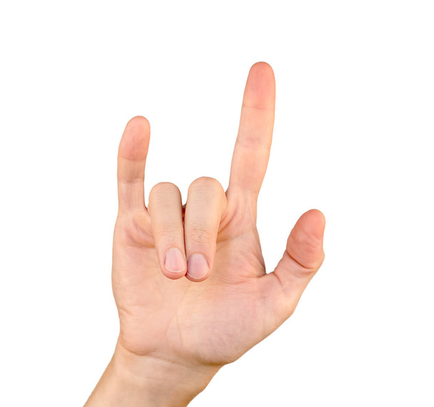 Een hand tonen hoorns gebaar geïsoleerd op witte achtergrond - Foto, afbeelding