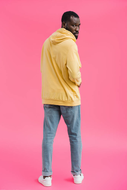 stylish african american man looking at camera on pink background - Fotoğraf, Görsel