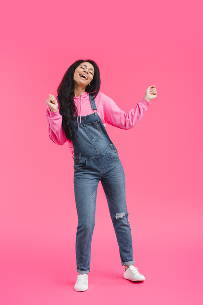 attractive stylish young african american woman dancing on pink background  - Fotografie, Obrázek