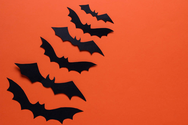 El concepto de la fiesta de Halloween. murciélagos sobre un fondo naranja con un lugar para una inscripción. vista superior
 - Foto, Imagen
