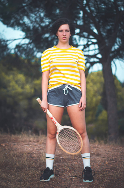 portrait with vintage clothes and wooden racket - Photo, Image