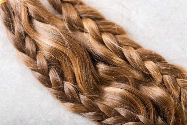 Tagliare bei capelli lunghi come donazione per la carità dei bambini, che rende parrucche per i pazienti oncologici, sfondo chiaro
 - Foto, immagini