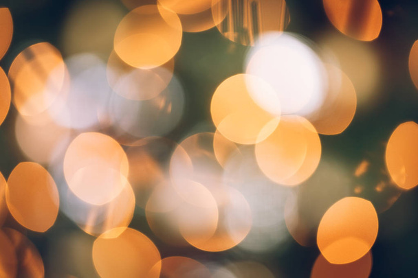 Seasonal bluured background of Christmas lights on the tree. Celebration concept. Soft focus. Horizontal - Photo, Image