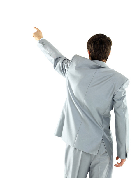 Businessman pointing at wall. rear view. Isolated over white . - Fotoğraf, Görsel
