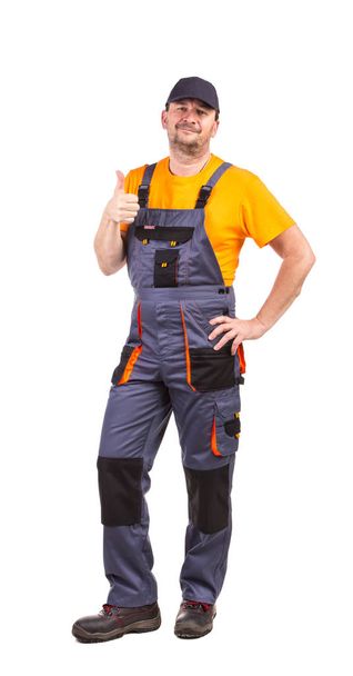 Male model dressed in special clothes for the workers. It is isolated in a white background. - Foto, immagini