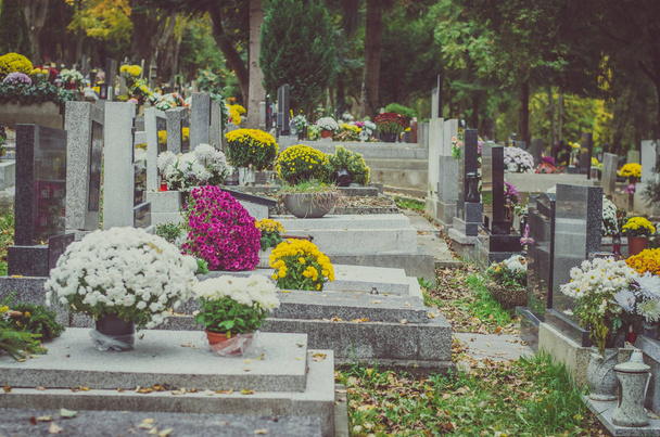tumbas decoradas en el cementerio durante el día de Todos los Santos en otoño
 - Foto, Imagen