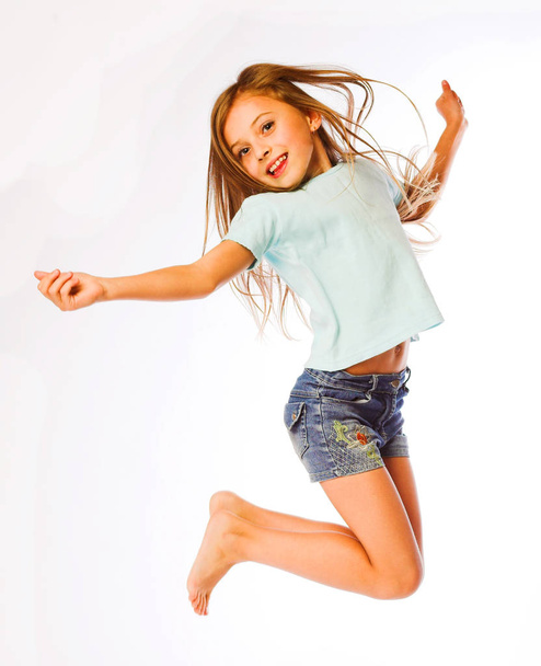 girl jumps on a white background - Foto, afbeelding