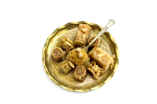 Oriental sweets "baklavadakia" on a metal plate on a white background close-up. - Photo, Image
