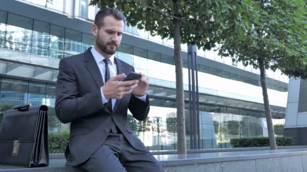 Beard Businessman Upset for Loss while Using Smartphone - Video
