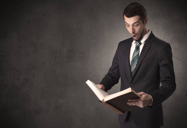 Businessman holding a book. - Foto, Bild
