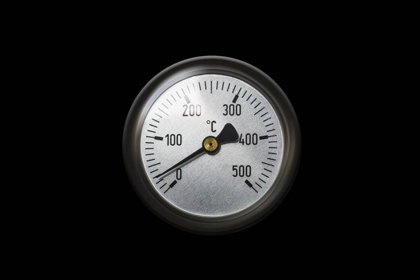 Celsius thermometer temperature gauge from a heater isolated on black background. With clipping path - Zdjęcie, obraz