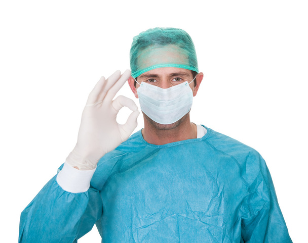 Male surgeon in scrubs uniform making Okay gesture - 写真・画像