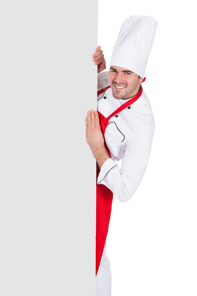 Chef in uniform presenting empty banner - Foto, imagen