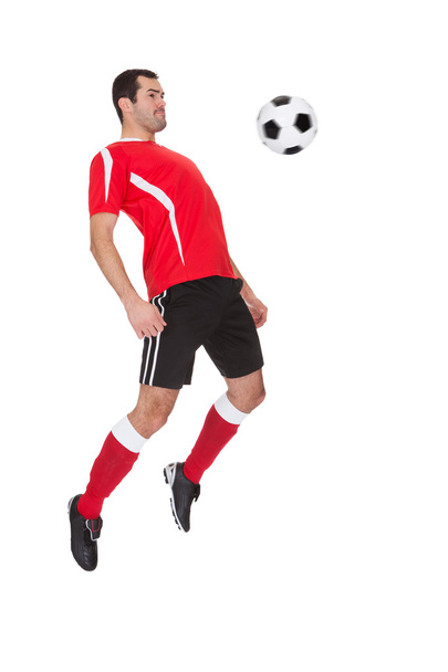 Professional soccer player kicking ball - Zdjęcie, obraz