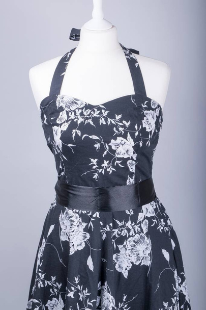 A Tailors Mannequin dressed in a Black and White Floral Dress with Satin Bow - 写真・画像