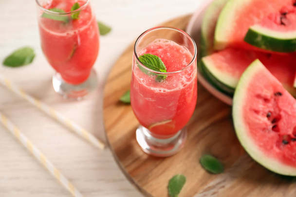 Glass with fresh smoothie and watermelon slices on wooden board - Fotoğraf, Görsel