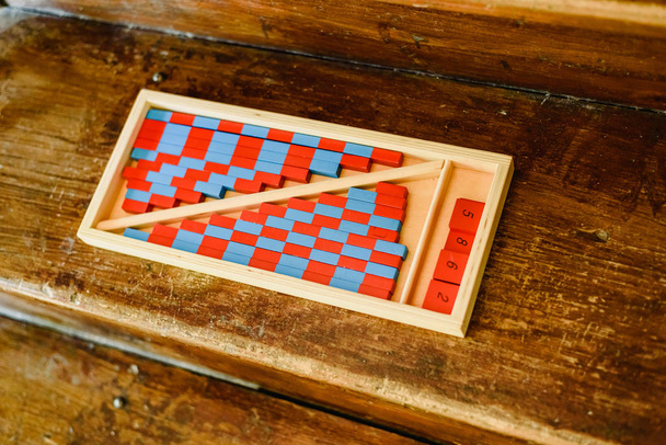 Game to learn to count, made of blue and red wood, inside a classroom montessori. - Photo, Image